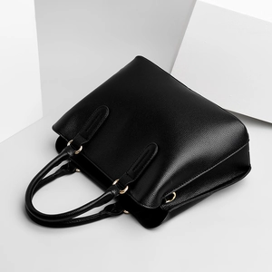 Chic black lychee grain leather tote bag with gold metal hardware in a 45-degree view