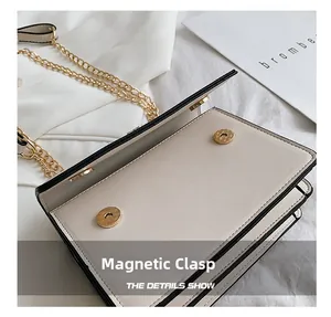 Detail shot of the cream crossbody bag featuring a secure magnetic snap button closure