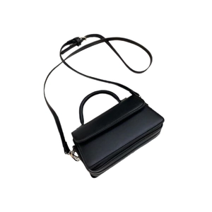 Minimalist black leather square crossbody bag with top handle and adjustable shoulder strap