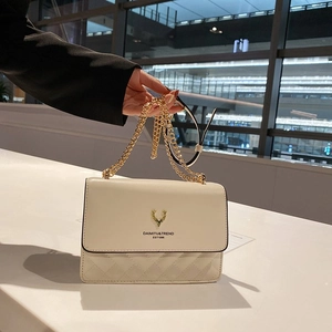 Minimalist off-white crossbody bag with gold deer logo and diamond quilted pattern