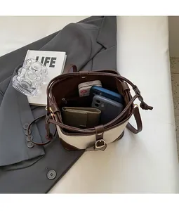 Close-up of contrast bucket bag showing large interior space for phone and wallet