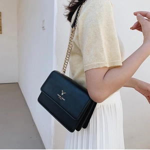 Classic black leather crossbody bag with golden chain strap and deer head logo for women
