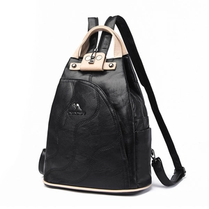 Vintage women's black pebbled leather backpack with beige handle and kangaroo metal logo