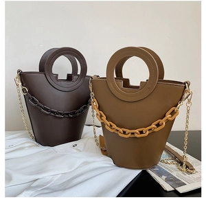 Chic women's leather bucket bag with thick chain decor and metallic shoulder strap