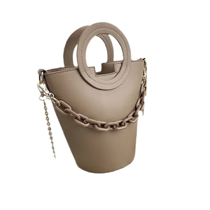 Minimalist taupe bucket bag for women with round handle and decorative thick chain detail