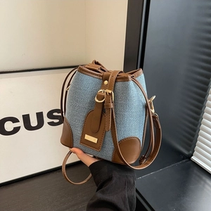 Blue tweed bucket bag with brown leather trim and golden hardware for women