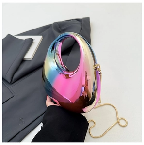Detail of gradient metallic shell bag with golden chain strap and oval cutout handle