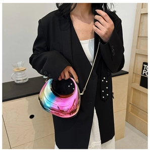 Detail of a holographic gradient crossbody bag with a sleek metallic finish and gold chain