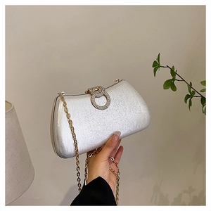 Detail of silver glitter evening clutch bag with diamond-encrusted double-ring buckle