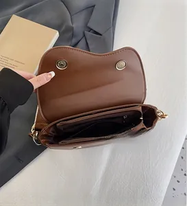 Detail view of the interior multi-layer compartments and brown PU leather of the saddle bag