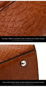 Detail of brown faux leather snake pattern texture and silver protective metal stud