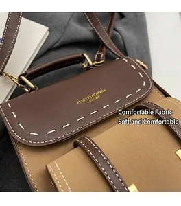 Detail of retro color-block bag showing contrast stitching and gold-toned hardware