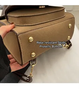 Detail of bag bottom with four gold wear-resistant rivets and premium stitching
