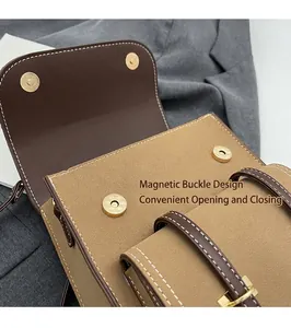 Detail of vintage leather bag showing magnetic snap closure and contrast stitching