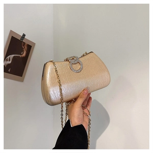 Elegant champagne satin evening clutch with rhinestone buckle and gold chain strap