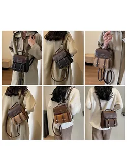 Detailed view of vintage leather backpack with contrast stitching and metal buckle