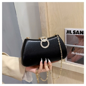 Elegant black evening bag with a gold chain strap and rhinestone-encrusted buckle