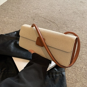 Schicke beige Webhandtasche mit braunem Lederbesatz und Schultergurt in stilvollem Design
