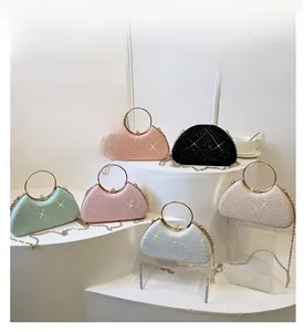Multiple colors of glitter evening clutch bags with gold metal handles on display