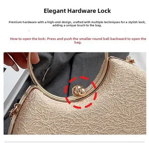 Detailed macro view of the gold evening bag featuring its metallic sphere clasp and ring handle