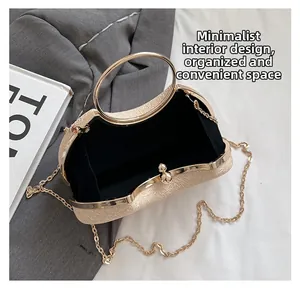 Detail of evening clutch bag interior featuring cream leather and golden ring handles
