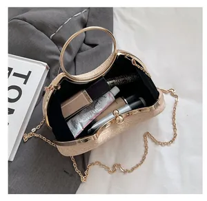 Detail of evening clutch bag interior showing spacious room for cosmetics and gold handle