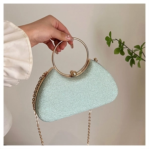 Sparkling light green evening box bag with a golden circular handle and chain strap