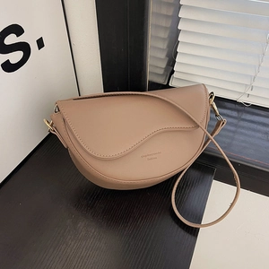 Retro khaki saddle bag with wide strap and matte finish in minimalist crossbody style