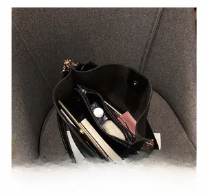 Interior view of black tote bag showing spacious compartments and metal hardware