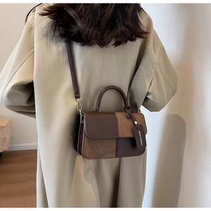 Model wearing a retro contrast-color small square bag in brown leather with a long strap