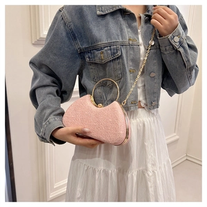 Pink lace texture evening handbag with gold round handles and a delicate chain strap