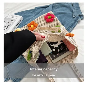 Spacious interior of beige straw tote bag with 3D crochet flowers holding a tablet and essentials