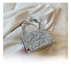 Close-up of silver wavy texture acrylic evening bag with metal ring handle and chain