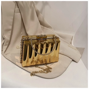 Detail of gold box clutch with vertical pleated texture and elegant metal handle