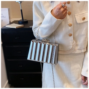 Close-up of silver mirror box bag featuring vertical 3D pleated metallic texture