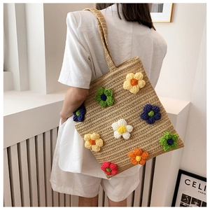Handmade woven straw tote bag with colorful 3D crochet flowers and adjustable shoulder strap