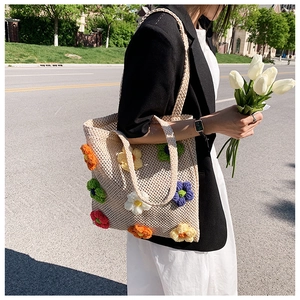 Hollow knit tote bag with colorful 3D crochet flowers and elegant top handle strap