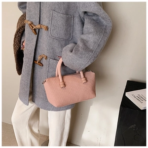 Detail of light pink tote bag with unique 3D bubble texture and round tubular handles