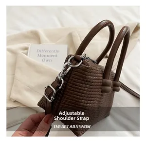 Detail of adjustable leather shoulder strap and weave texture on coffee tote bag
