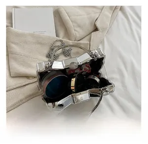 Clear acrylic box bag with silver metal frame showing interior capacity for makeup