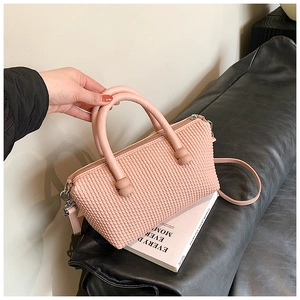 Detailed view of pink tote bag with textured bubble design and silver metal hooks