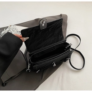 Macro view of the internal compartments and zipper pocket of the black wrinkled leather bag