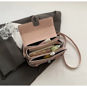 Detail showing the internal storage capacity and three-layer structure of the pink bag
