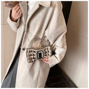 Silver bow evening clutch with black gemstone and delicate metal chain link strap