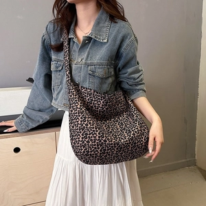 Fashionable leopard print crescent crossbody hobo bag styled for casual daily wear