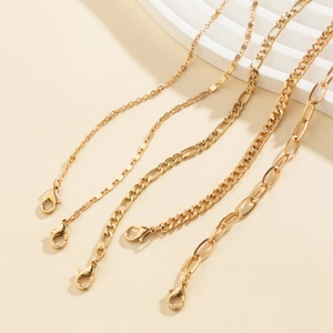Five-piece stackable gold metal chain bracelets set featuring diverse stylish link patterns