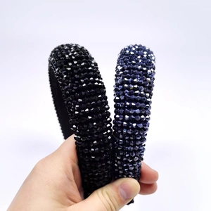 Sparkly crystal padded headband set in deep black and shimmering purple blue colors