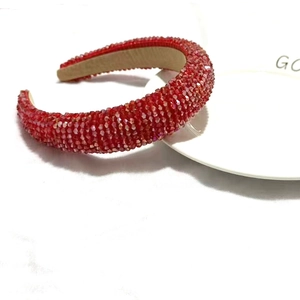 Detailed view of red crystal padded headband with sparkling faceted rhinestones