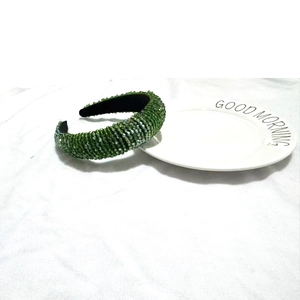 Detail view of handcrafted green crystal beaded headband with luxury sponge padding