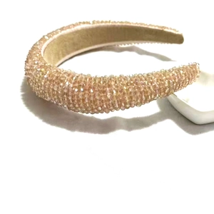 Macro shot of sparkling champagne pink crystal beads on a wide sponge headband detail